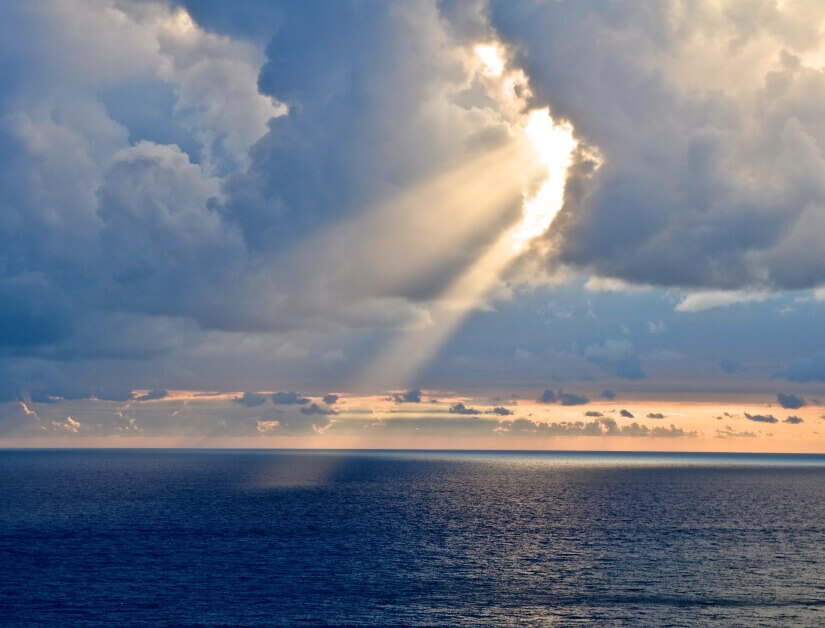 Licht durchbricht Wolkendecke über Wasser