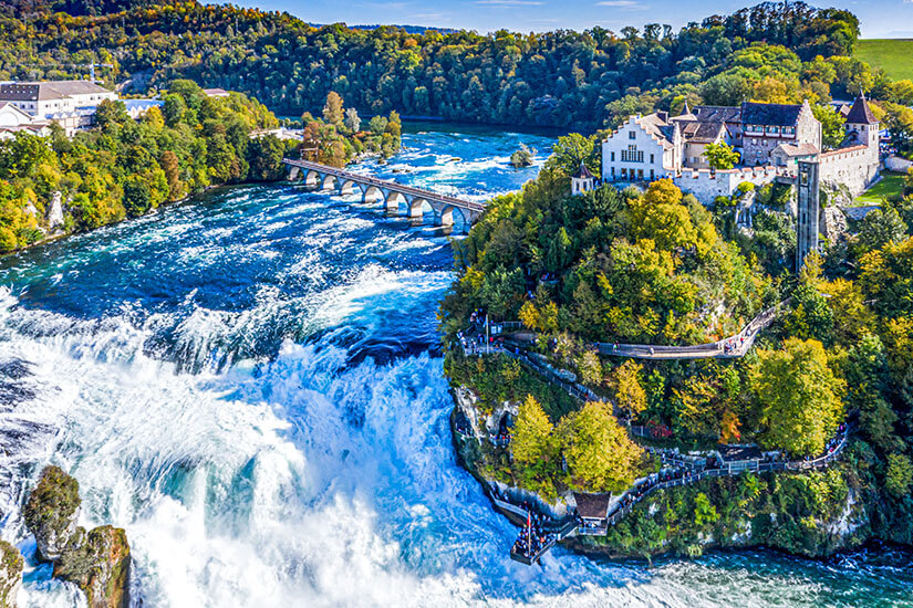 Der Rheinfall bei Schaffhausen ist der größte Wasserfall Europas und ein beeindruckendes Naturschauspiel direkt an der deutsch-schweizerischen Grenze. Die tosenden Wassermassen sorgen für eine natürliche Abkühlung und machen ihn zu einem idealen Coolcation-Reiseziel auch ab Deutschland. Felsen, Gischt und historische Gebäude schaffen eine einzigartige Kulisse. Coolcation Europa Schweiz