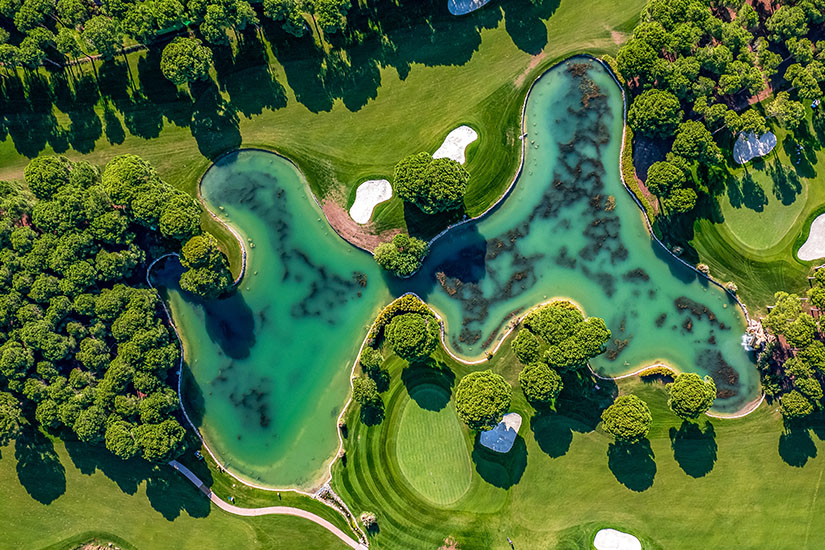 Aus der Vogelperspektive zeigt sich ein üppig begrünter Kurs, durchzogen von großzügigen Wasserflächen und eingebettet in dichten Baumbestand. Die geschwungenen Fairways und sorgfältig platzierten Bunker verraten anspruchsvolles Kursdesign. Ein Platz, der Schönheit mit sportlicher Herausforderung verbindet. Golfdestinationen weltweit Tuerkei