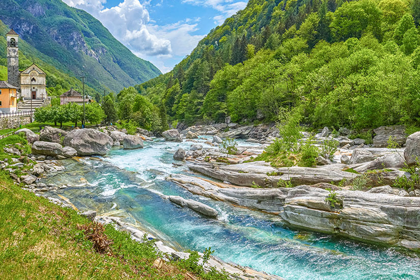Die Verzasca schlängelt sich mit türkisblauem Wasser durch das gleichnamige Tal im Tessin und bildet dabei eine einzigartige Flusslandschaft aus glattem Gneis und üppigem Grün. Das Valle Verzasca ist für seine unglaubliche Wasserklarheit bekannt – ein Paradies zum Baden, Wandern und Tauchen. Die kleine Kirche am Ufer und die mächtigen Felsblöcke machen diese Stelle zu einem der schönsten Orte der Schweiz. Verzascatal Schweiz Fluss