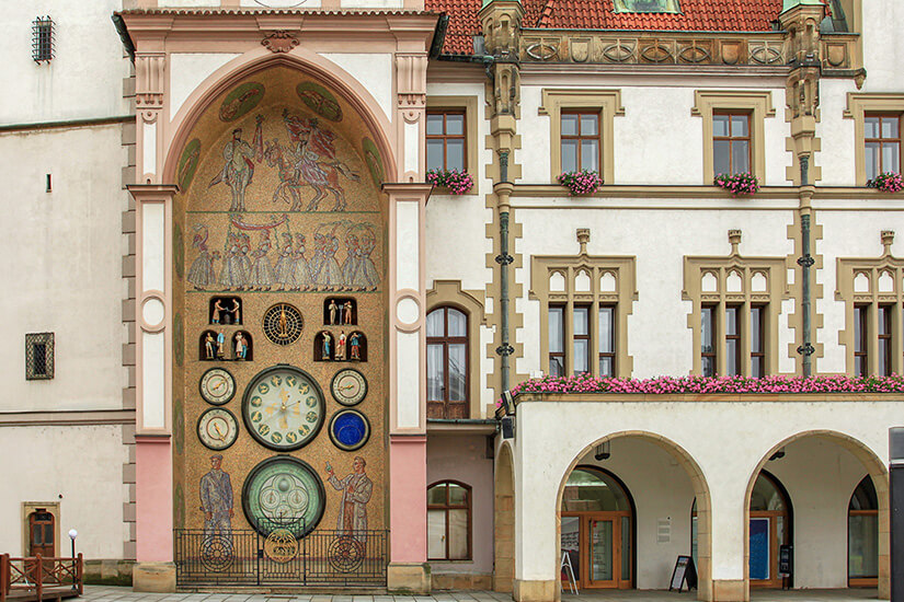 Die astronomische Uhr am Rathaus zählt zu den nur wenigen ihrer Art weltweit. Nach Beschädigungen im Zweiten Weltkrieg wurde sie 1955 im sozialistisch-realistischen Stil neu gestaltet. Die Figuren setzen sich täglich um 12 Uhr in Bewegung. Olomouc Tschechien Strasse